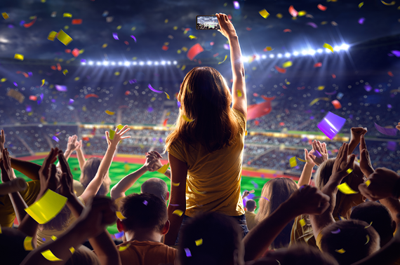 female-takes-selfie-at-crowded-stadium-falling-confetti